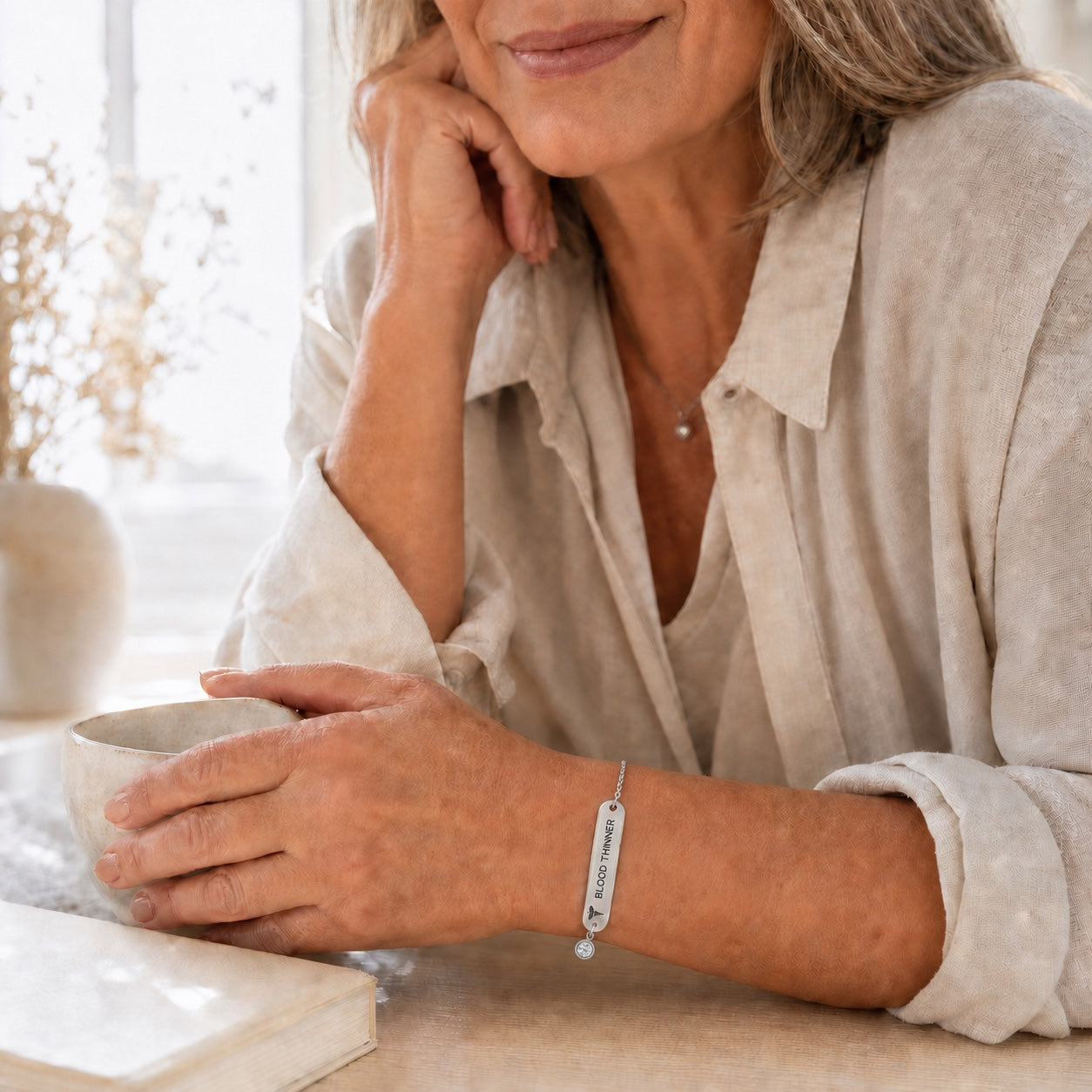 Mature woman wearing the silver-color DAYMERIT bracelet with everyday clothing